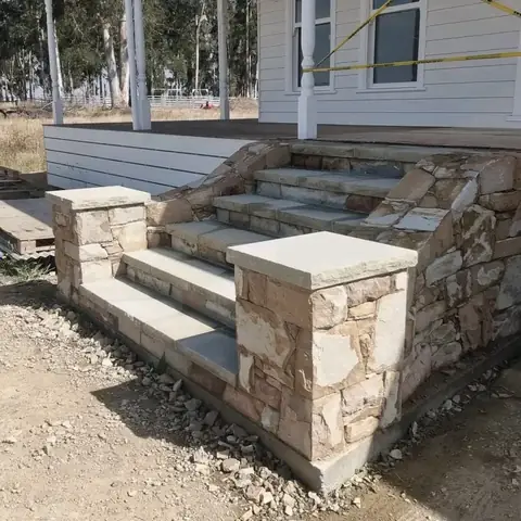 Stone steps with sandstone pillars leading to a house entrance (2 of 4)