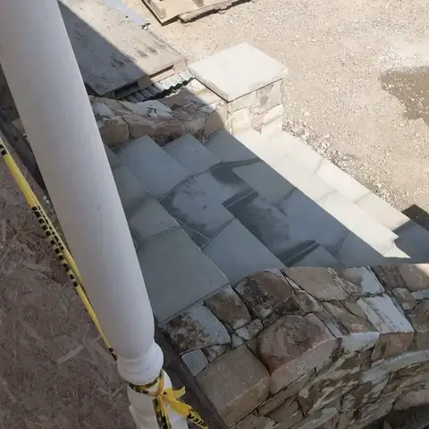 Stone steps with sandstone pillars leading to a house entrance (3 of 4)