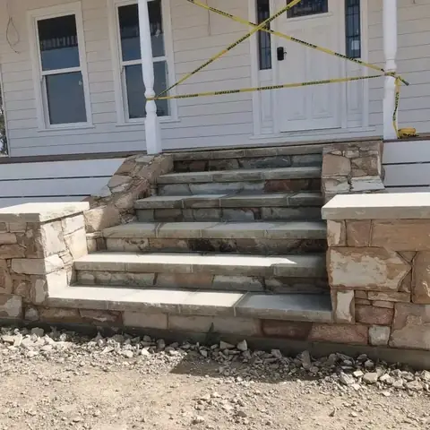 Stone steps with sandstone pillars leading to a house entrance (4 of 4)